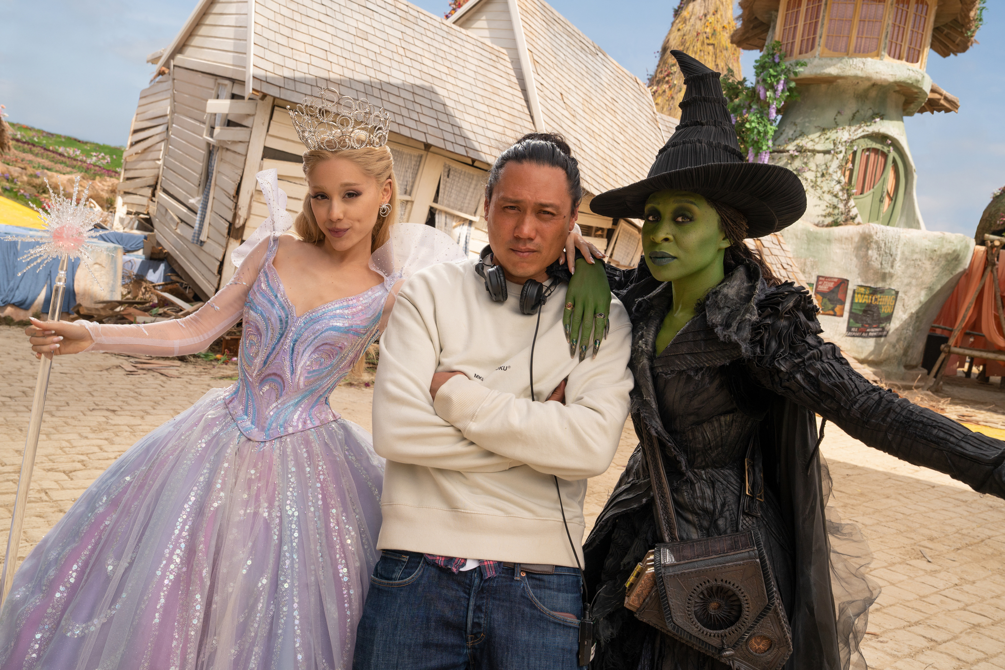 L to R: Ariana Grande (as Glinda), Director Jon M. Chu, and Cynthia Erivo (as Elphaba), on the set of WICKED FOR GOOD, directed by Jon M. Chu. © Universal Studios. All Rights Reserved.