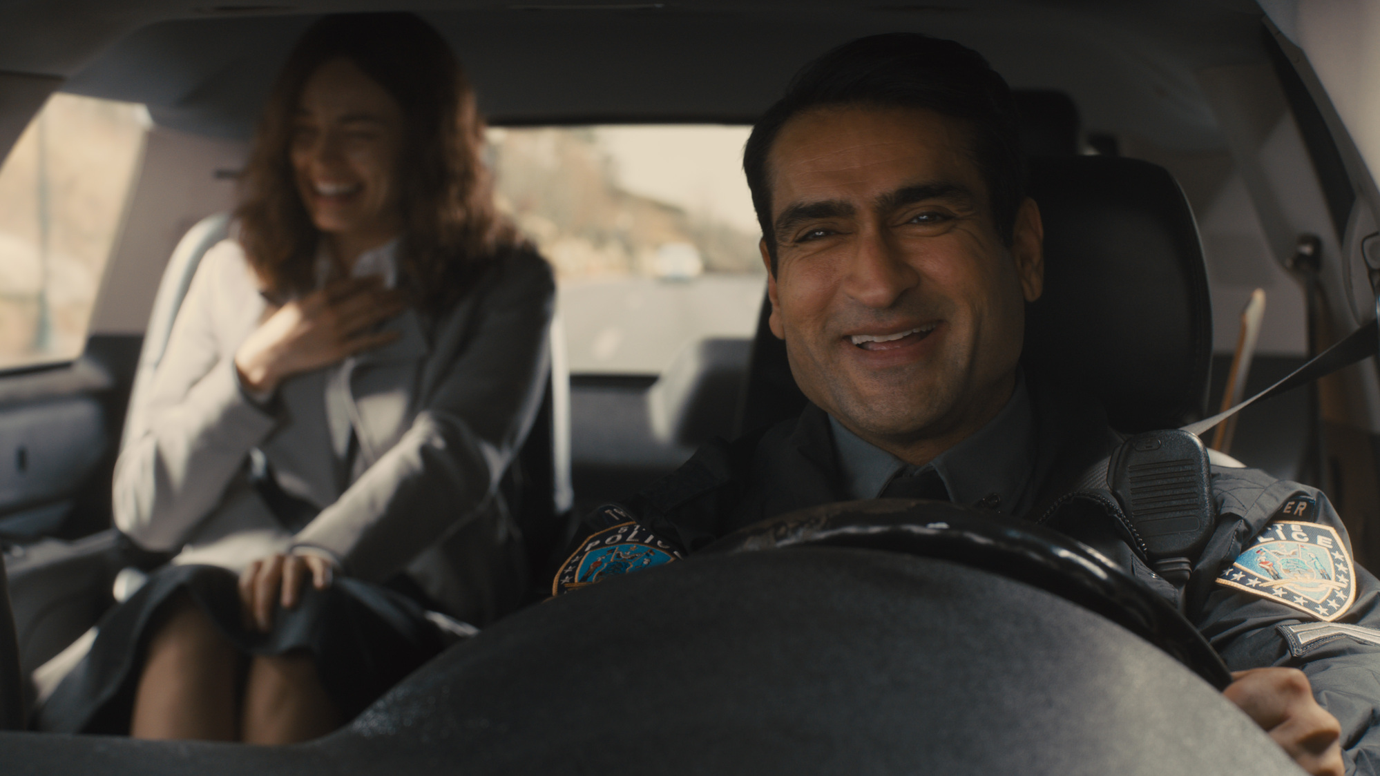 (L-R): Emma Mackey as Ella McCay and Kumail Nanijiani as Trooper Nash in 20th Century Studios' ELLA MCCAY. Photo courtesy of 20th Century Studios. © 2025 20th Century Studios. All Rights Reserved.