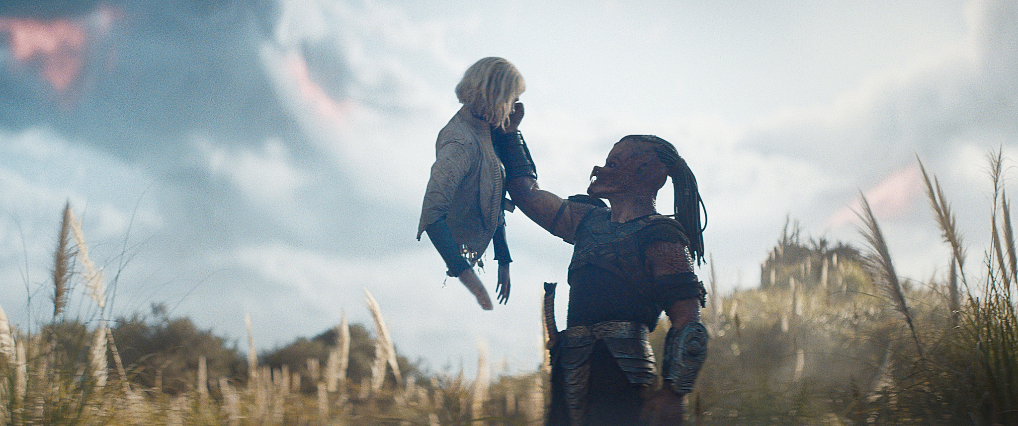 (L-R) Thia (Elle Fanning) and Dek (Dimitrius Schuster-Koloamatangi) in 20th Century Studios' PREDATOR: BADLANDS film. Photo courtesy of 20th Century Studios. © 2025 20th Century Studios. All Rights Reserved.