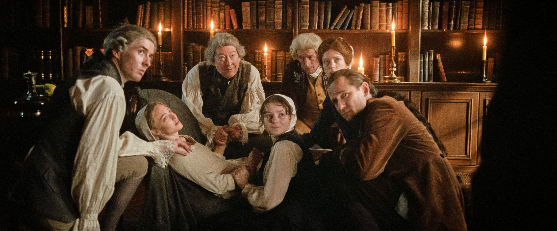 From L to R: Matthew Beard, Amanda Seyfried, Scott Handy, Thomasin McKenzie, Jeremy Wheeler, Stacy Martin, and Lewis Pullman in THE TESTAMENT OF ANN LEE. Photo courtesy of Searchlight Pictures. © 2025 Searchlight Pictures All Rights Reserved.