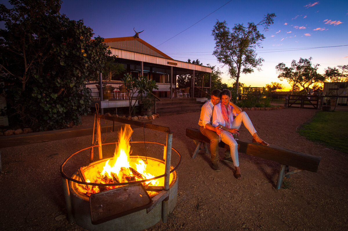 Bullara Station Stay western australia Couple by campfire at Bullara Station
